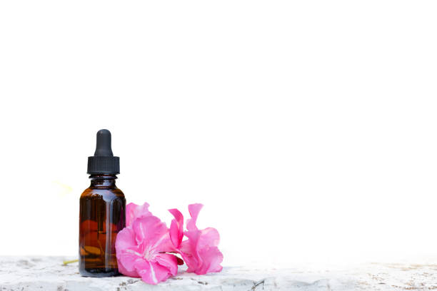 istock Brown dropper bottle with pink flowers on white background 2186812556