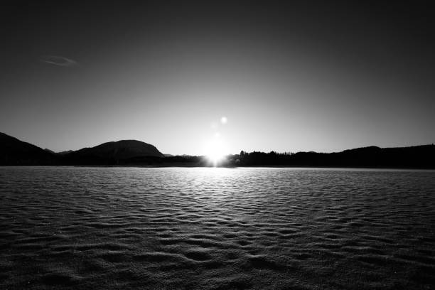 istock Serene lake landscape at sunrise in black and white. 2186813039