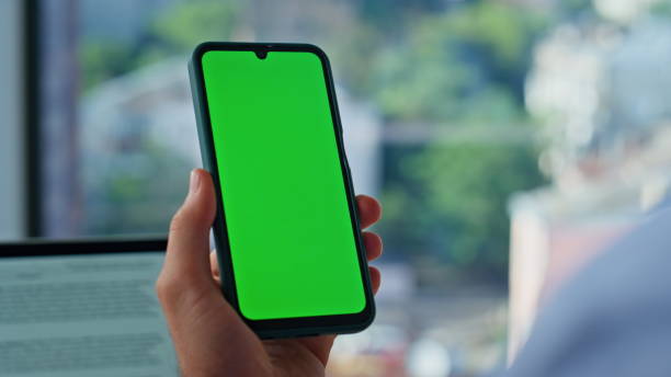 istock Entrepreneur scrolling greenscreen cellphone application at workplace closeup. 2186813152