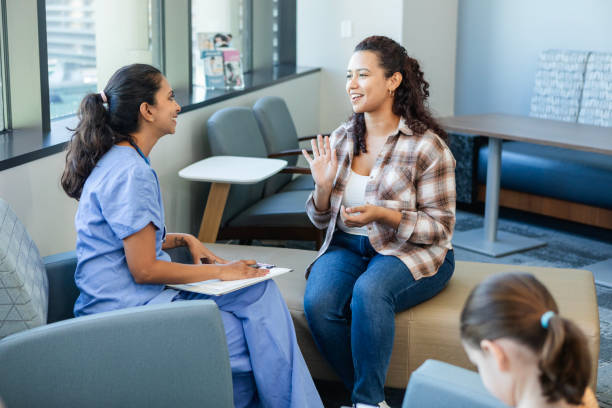 istock Young mom gestures while talking about her daughter's health with doctor 2186814599