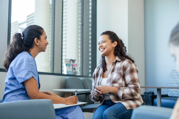 istock Relieved mom smiles at daughter's pediatrician 2186814612