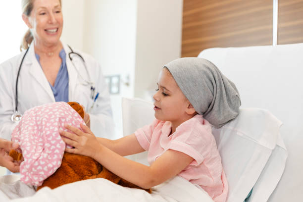 istock Young cancer patient playing with stuffed animal toy 2186814640