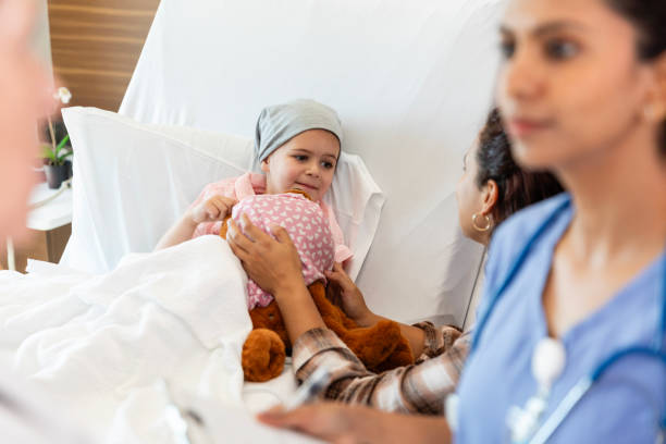 istock Young pediatric cancer patient looks at her mom 2186814656