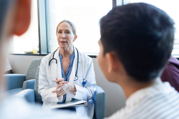 istock Mature doctor has serious conversation with twin brothers 2186814670