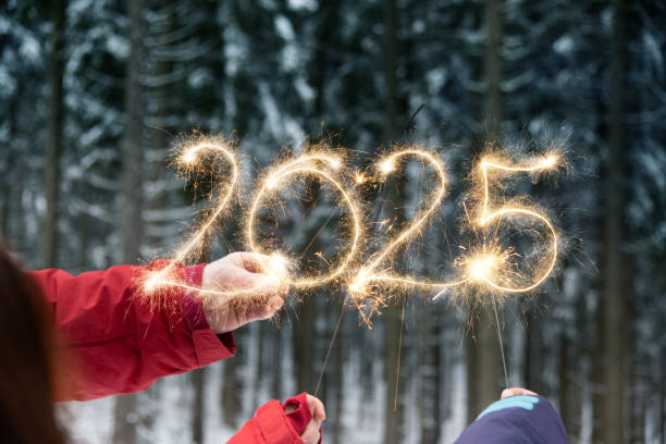 istock Hands writing 2024 with sparklers - New Year Celebration Party 2186814923