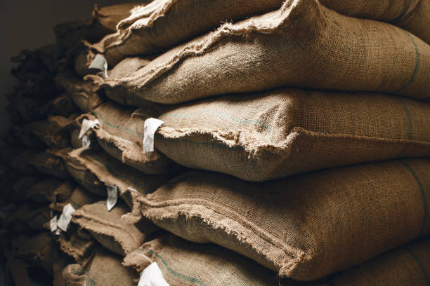 istock Stacks of Burlap Sacks Filled With Fresh Green Coffee Ready for Industrial Scale Export in Storage Facility 2186815199