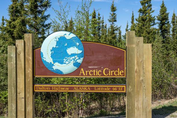 istock Marking the Arctic Circle on Dalton Highway, Alaska, surrounded by lush green forest 2186815253