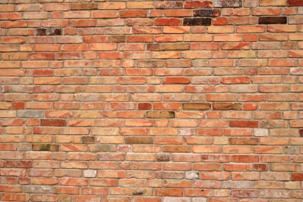 an Old brick wall, old texture of red orange stone blocks