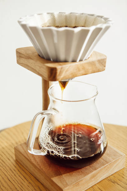 istock Brewing Coffee With an Origami Pour Over Setup on Wooden Table in Cozy Kitchen Setting 2186816627