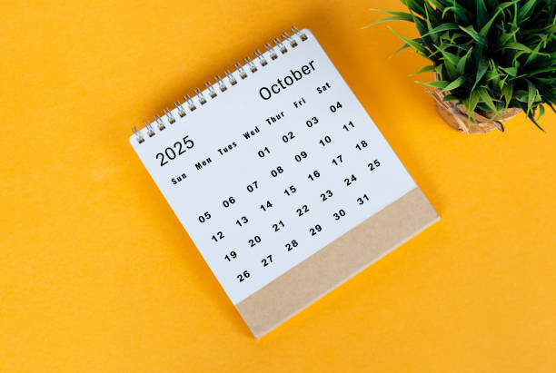 istock October 2025 desk calendar on yellow background. Directly above. Flat lay 2186818392