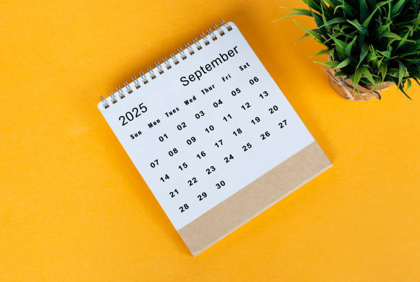 istock September 2025 desk calendar on yellow background. Directly above. Flat lay 2186818403