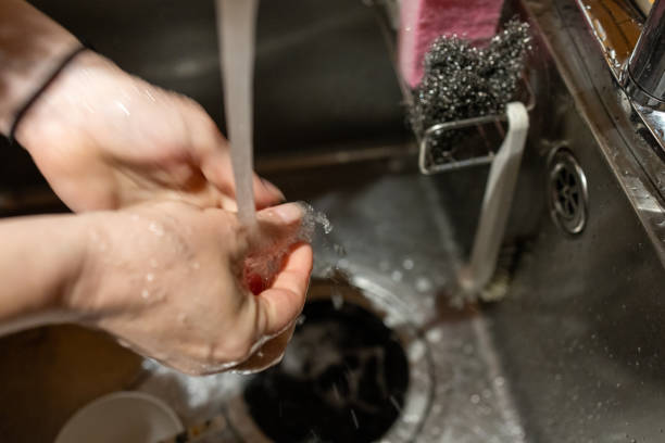 istock Hands Washing Under Running Water in a Kitchen Sink 2186818429