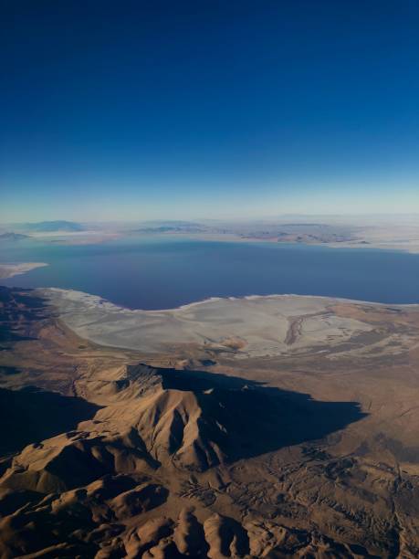 istock Utah topography from above with brown sandy dunes, blue lake, and sky 2186818506