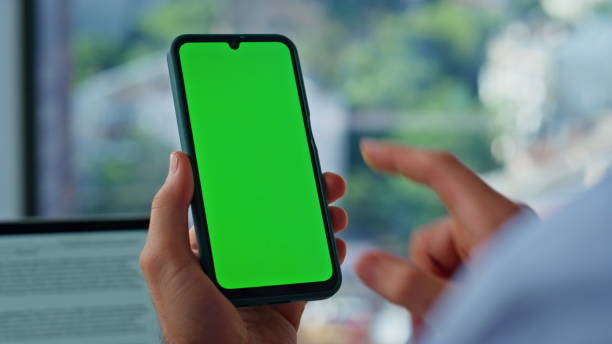 istock Businessman finger tapping chroma key cellphone browsing at workplace closeup. 2186818584