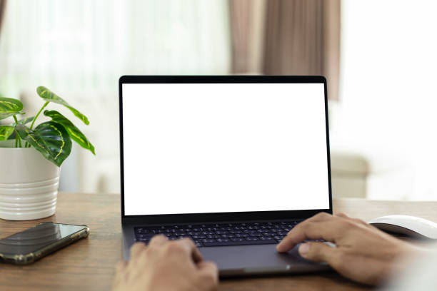 istock mock up businessman working empty screen computer on wood desk in home. Notebook Laptop with blank screen 2186819001