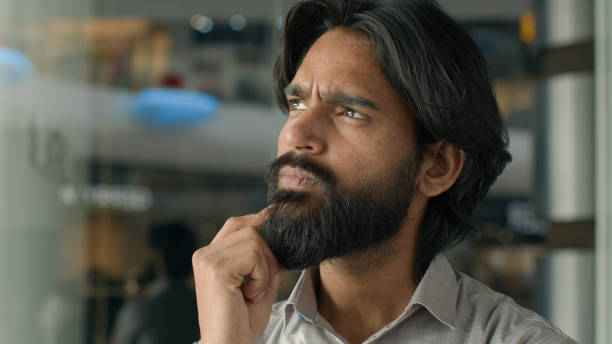istock Close-up concentrated pensive thoughtful Indian man male guy businessman creative developer freelance programmer thinking about business idea planning strategy consider proposal pondering think ponder 2186821045