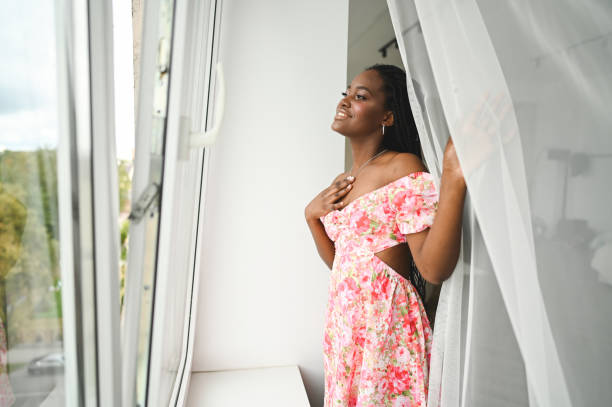 istock Cheerful woman looking throw window. 2186821249