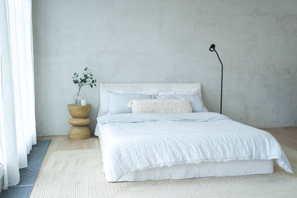 istock Stylish loft bedroom interior. Spacious design apartment with light walls large windows big bed. Clean modern decoration with elegant furniture in minimalist Scandinavian style 2186822021