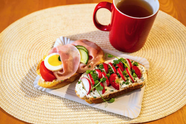 istock 2 different sandwich and red cup of drink on yellow pad on table 2186825079