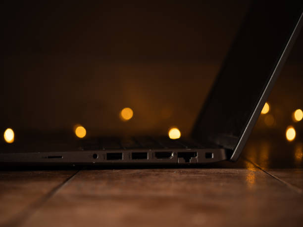 Laptop with with twinkling lights background bokeh