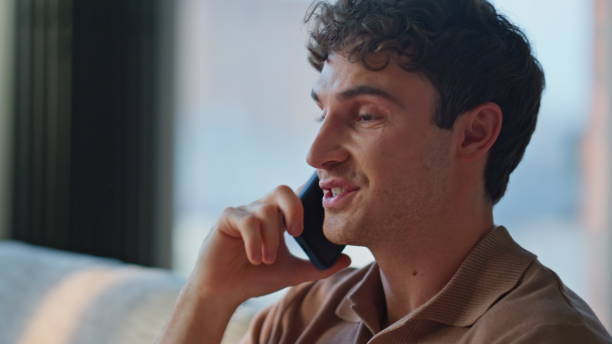 istock Home man talking cellphone relaxing on comfortable apartment sofa closeup. 2186825694
