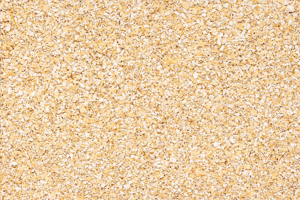 Macro photography of raw oat bran, coarse fiber, digestive supplement, fitness,  healthy natural flakes, porridge, traditional vegan food