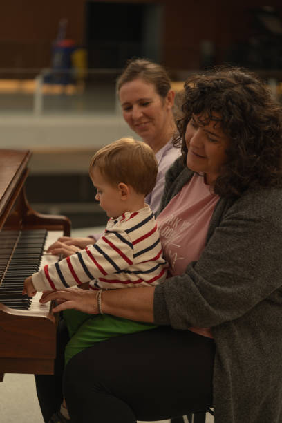 istock mothers play piano with their child 2186826592
