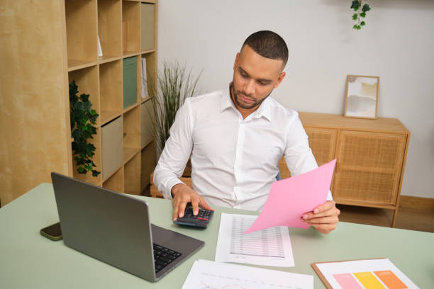 istock Accountant working with calculator and documents at desk in modern office 2186826757