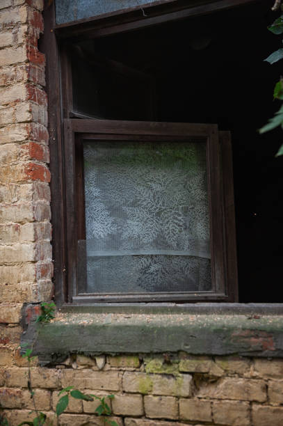 istock Old wooden rustic window on the ancient abandoned house 2186830466