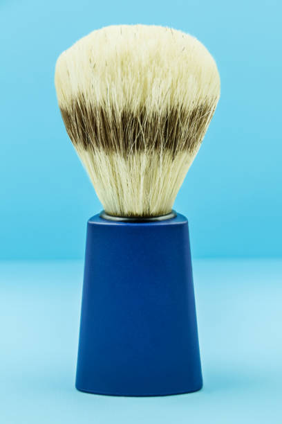 Shaving brush natural bristle against blue background