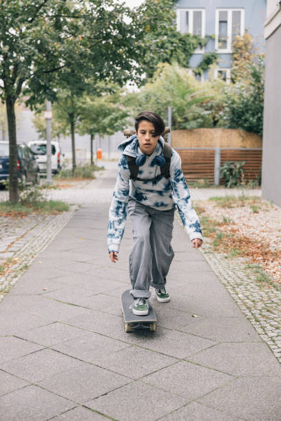 istock Girl student commuting on a skateboard 2186835462