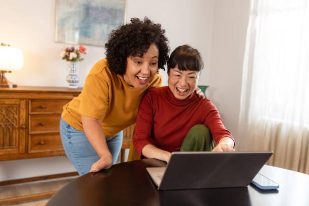 istock Lesbian couple using a laptop at home 2186836657