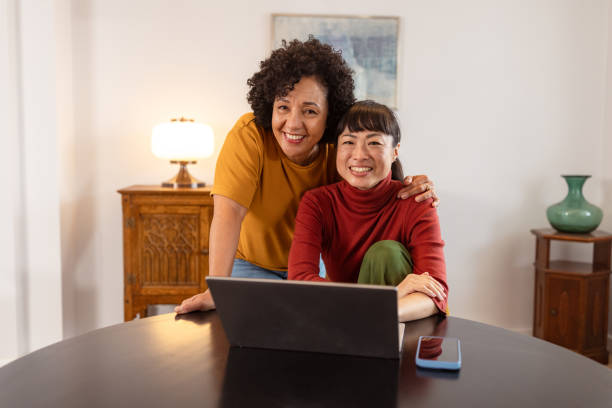 istock Happy couple using a laptop at home together 2186836666