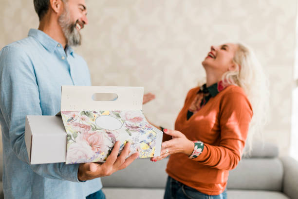 istock Husband at home surprising his  wife with a gift 2186837413