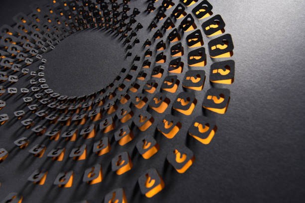 Intricate black paper artwork with layered question mark cutouts and glowing orange accents