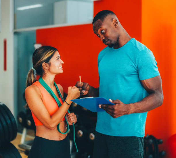 istock Sports training in the gym with personal trainer 2186837781