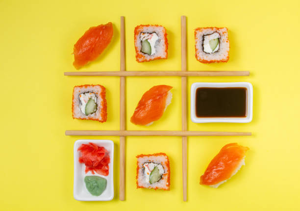 Creative Arrangement of Sushi and Sashimi on Yellow Background for Japanese Cuisine Concept