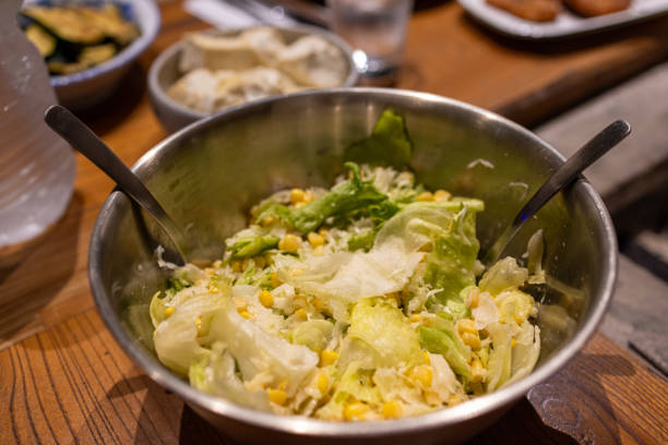 a popular green salad of romaine lettuce and croutons dressed with an emulsion-based dressing featuring lemon juice, olive oil, egg yolks, Worcestershire sauce, Parmesan cheese, and garlic