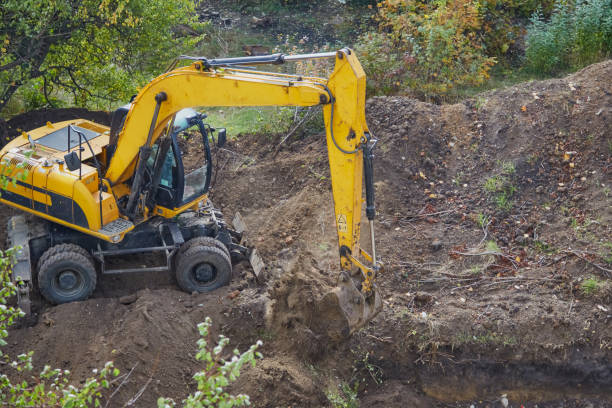 istock Excavator digging a pit with a bucket, excavator scooping soil with a bucket, excavator bucket working on a construction site 2186839008
