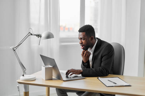 istock american man laptop online african education computer smiling student office job freelancer 2186839074