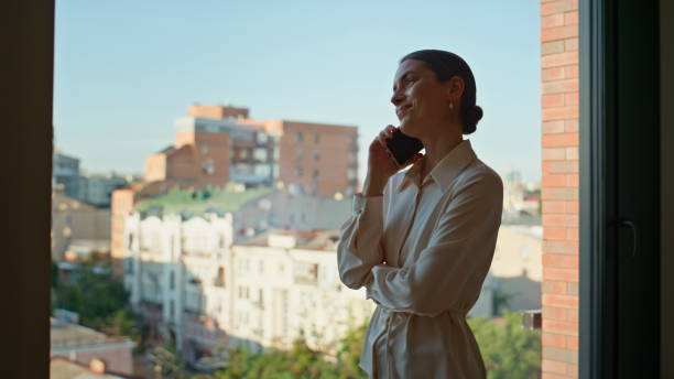 istock Confident lady boss calling mobile phone at office window closeup. Elegant woman 2186840658