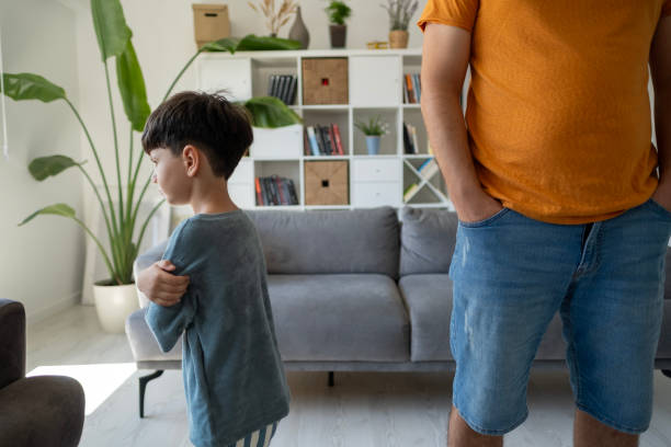 istock Annoyed father back to back with son ignoring each other after argue 2186841271