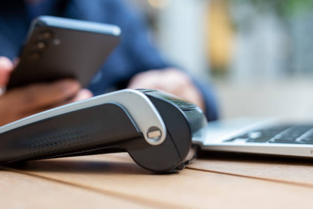 istock Businessman making mobile payment with nfc technology on pos terminal 2186842123