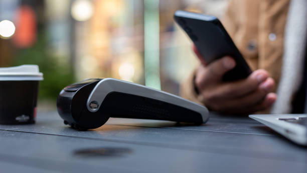 istock Customer paying contactless with mobile phone in cafe 2186842132