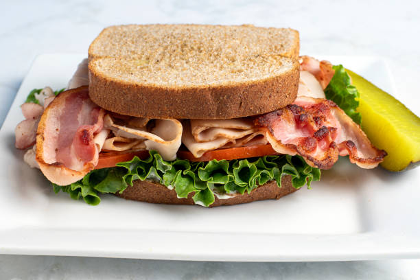 istock turkey blt sandwich  served with a pickle 2186846260