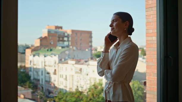 istock Successful lady talking mobile phone at panoramic office window closeup. 2186846531