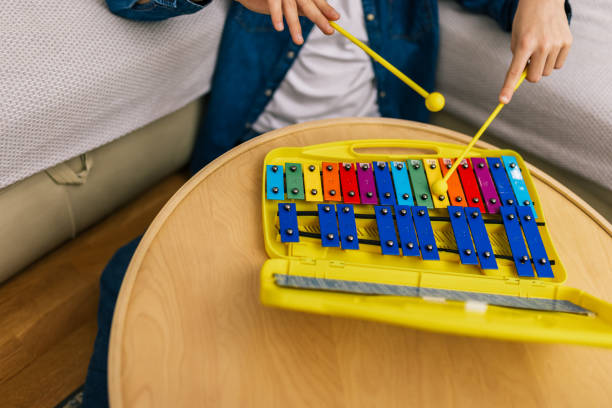 istock Boy plays metallophone at home. 2186846903