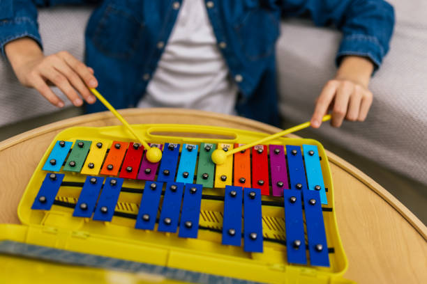 istock Boy plays metallophone at home. 2186846982