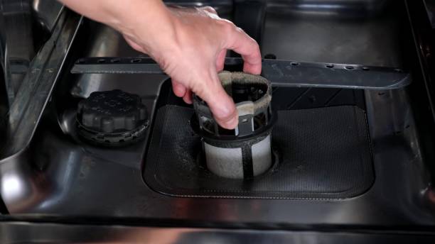 istock A hand taking out dishwasher filter to clean it, dis washer cleaning concept, kitchen home appliances care and maintenance 2186846987