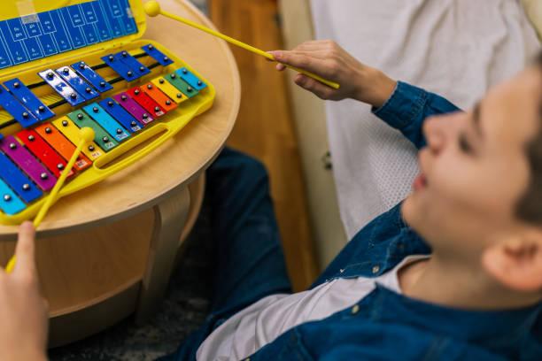 istock Boy plays metallophone at home. 2186847081